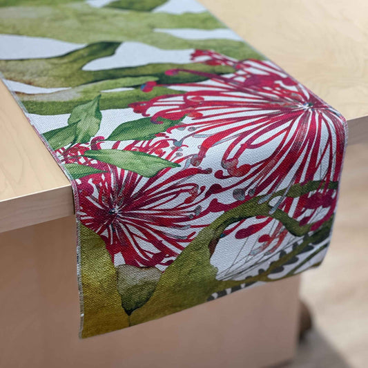 Binna Burra table runner with pink-red native flowers among green and yellow foliage